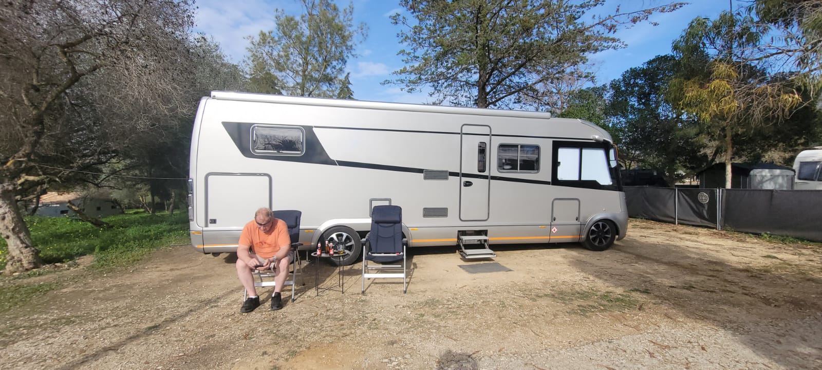 Relaxing outside the motorhome on a sunny campsite